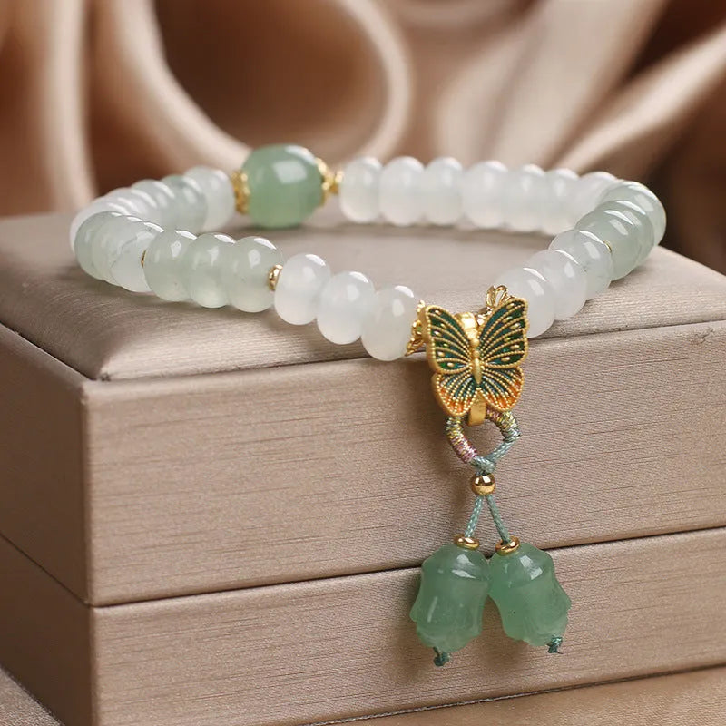 Green crystal women's bracelet with abacus beads and butterfly tassel decoration