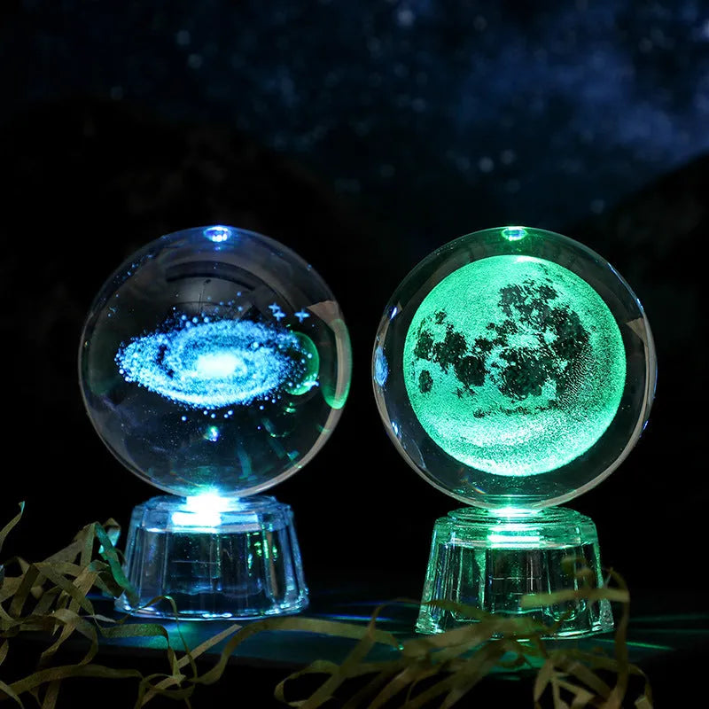 Transparent crystal ball ornament with inner carving on a table, 6cm in diameter with a modern base.