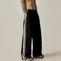 Black men's high waist wide leg climbing trousers on a hanger.