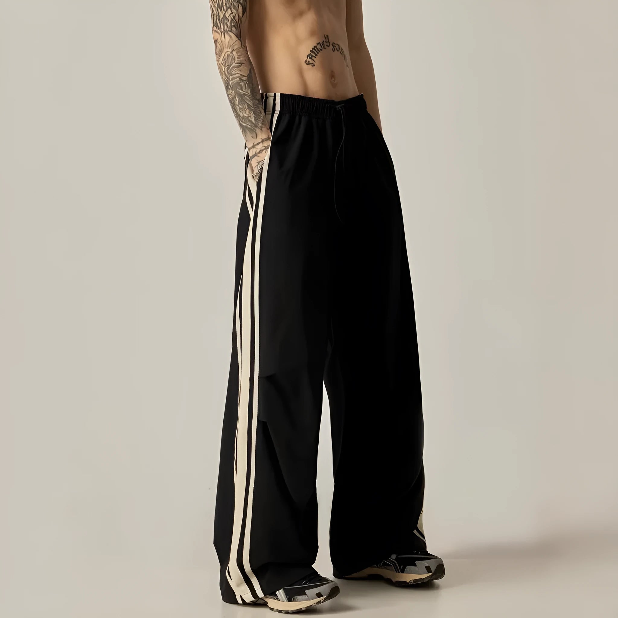Black men's high waist wide leg climbing trousers on a hanger.