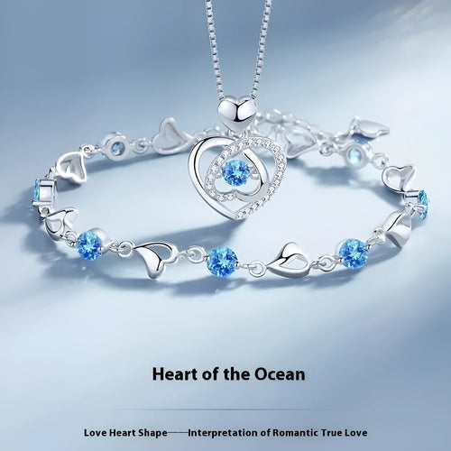 Blue diamond tone heart pendant necklace and matching bracelet set on a copper chain.