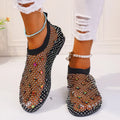 Colourful rhinestone detail on women's white mesh flat sandals with a round toe and rubber sole.