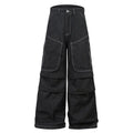 Black pleated denim jeans with multiple pockets, shown on a hanger.
