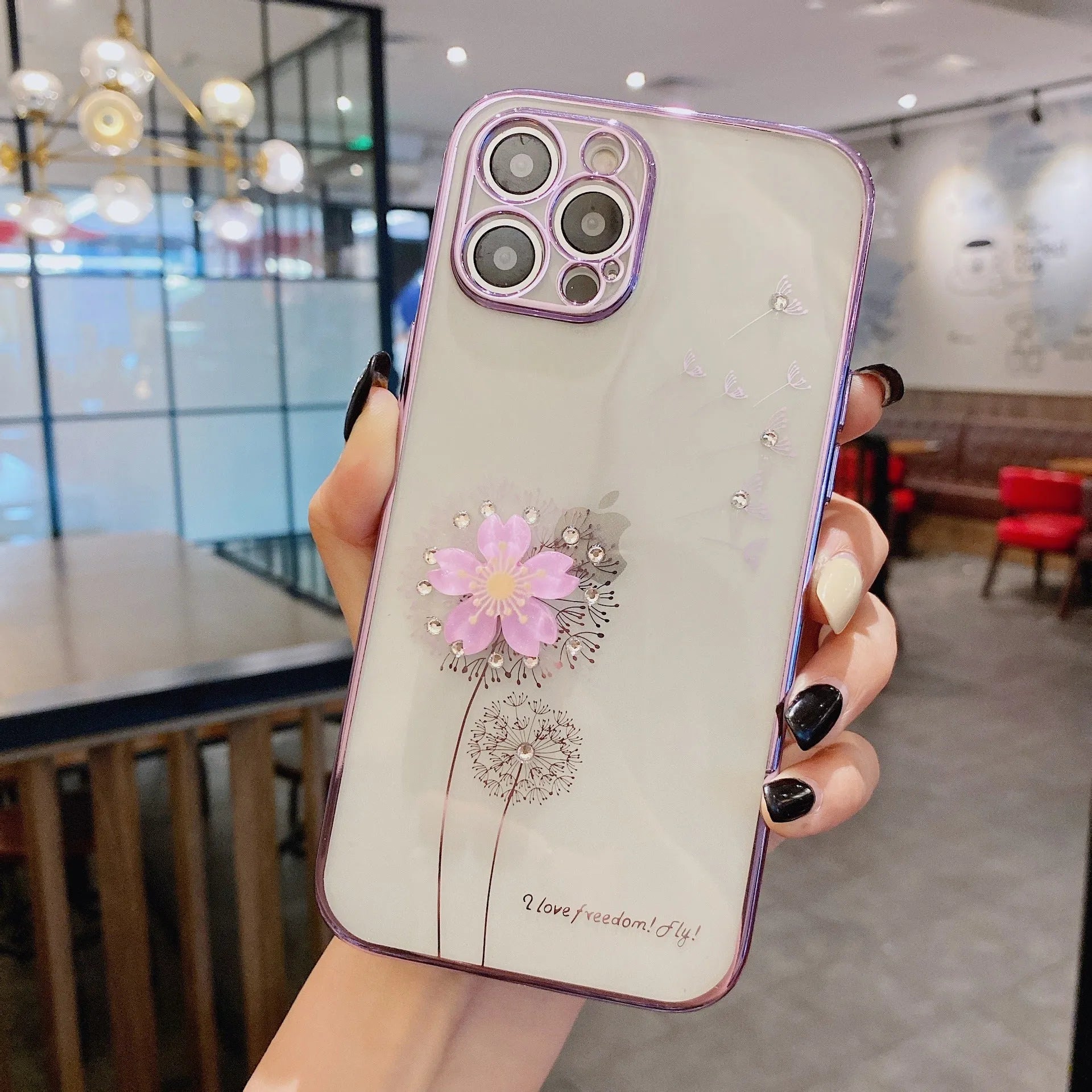 Green 3D flower spin stand phone case for iPhone on a table, showing built-in screen protector and stand.