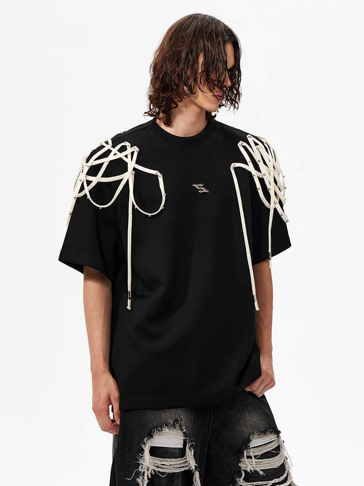 Black women's short-sleeved T-shirt with padded shoulders and rivet ribbon detail.