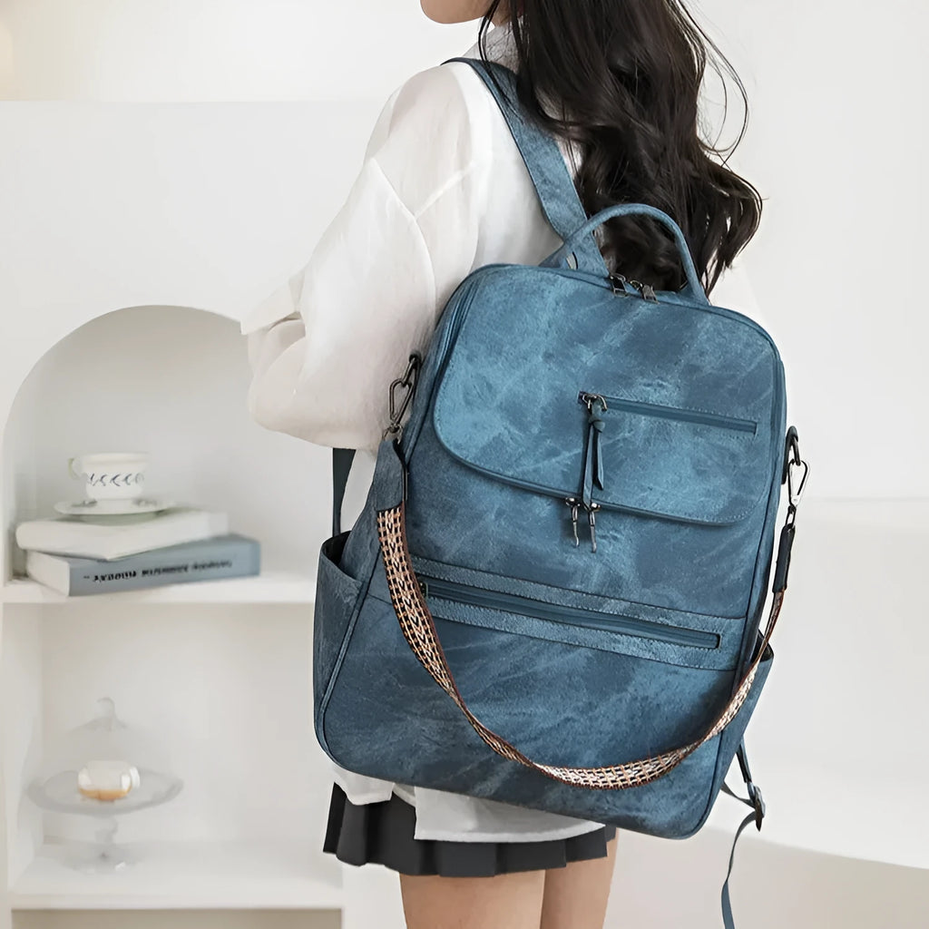 Retro college style PU backpack with curved shoulder straps shown in a solid colour with stitching detail.