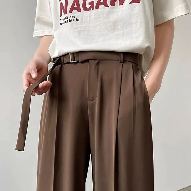 Black straight leg loose fit casual trousers on a hanger, front view.