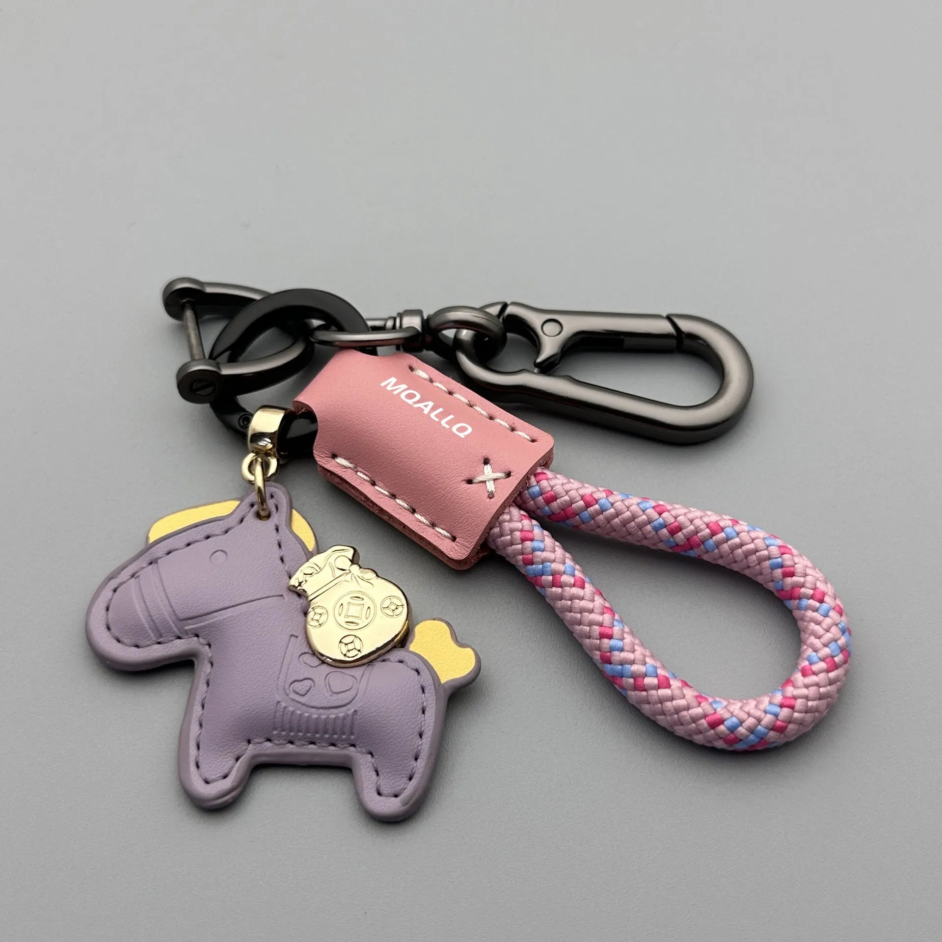 Handmade brown cowhide key ring pendant with a zinc alloy pony belt buckle and green flanelle rope.