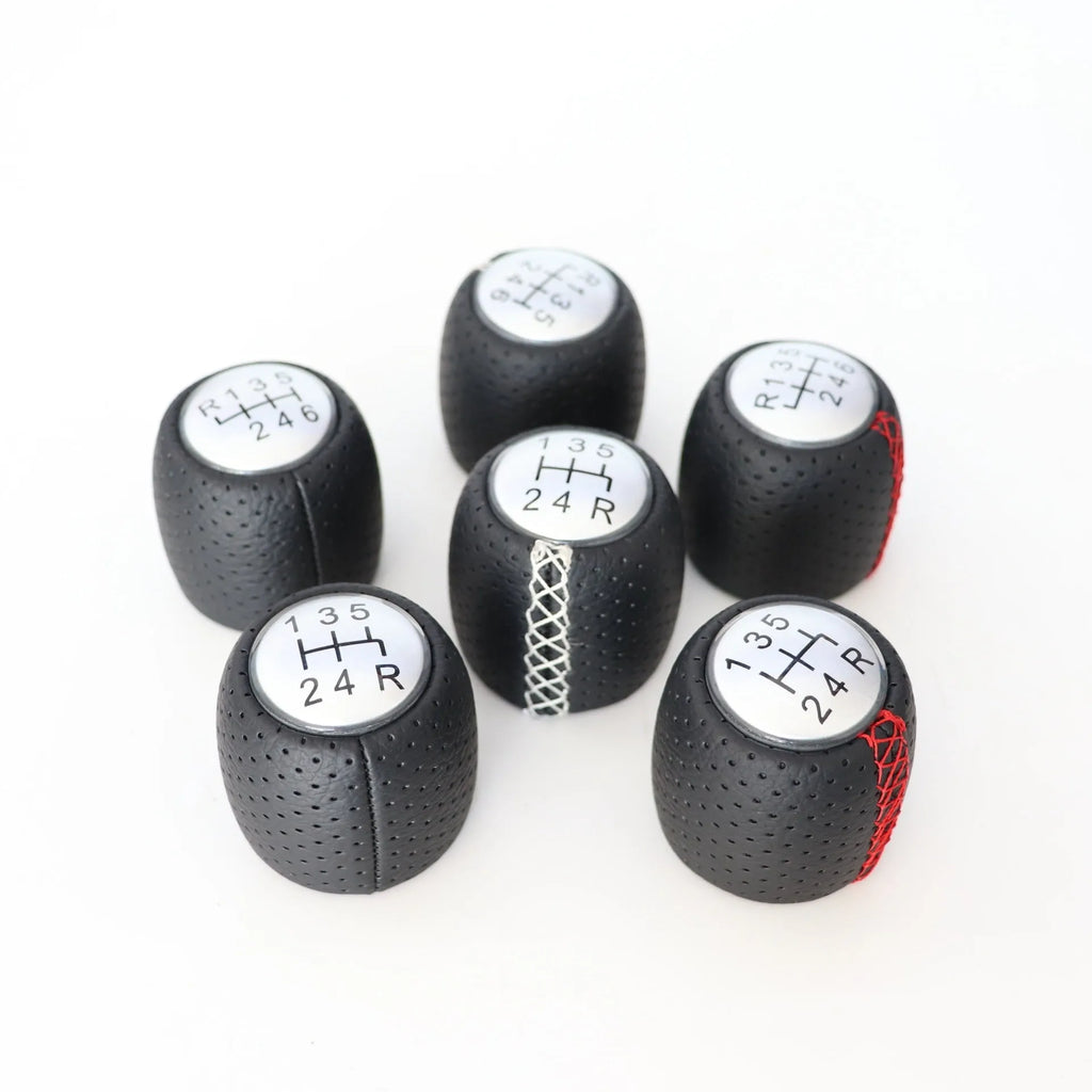 Sewn wrapped leather perforated style handball gear for Alpha vehicles in black, red, and white line options