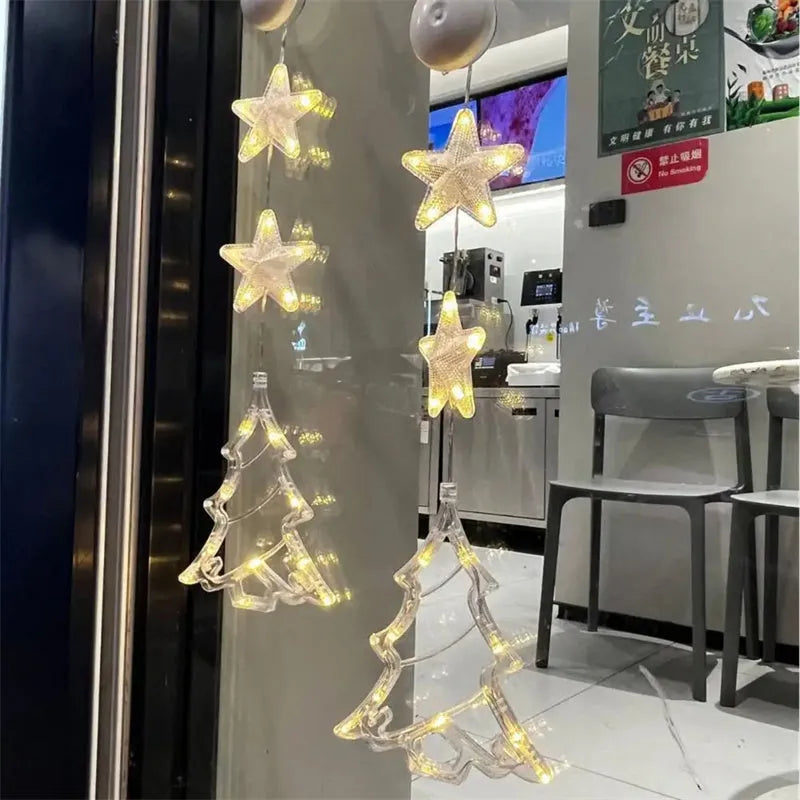 Set of three Christmas LED star window lights with suction cups on a glass window, warm glow, plastic housing, battery operated