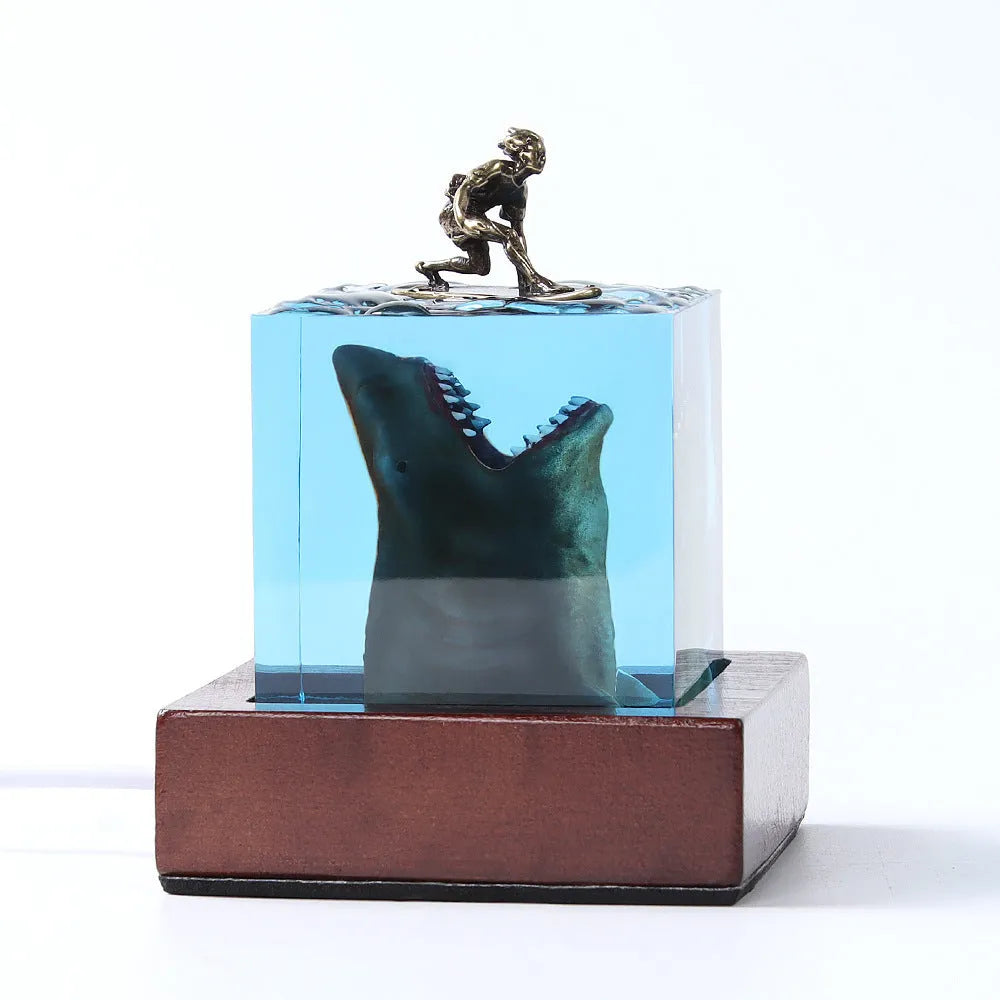 Clear epoxy resin shark surfer night light ornament with LED base in 5cm and 8cm sizes.