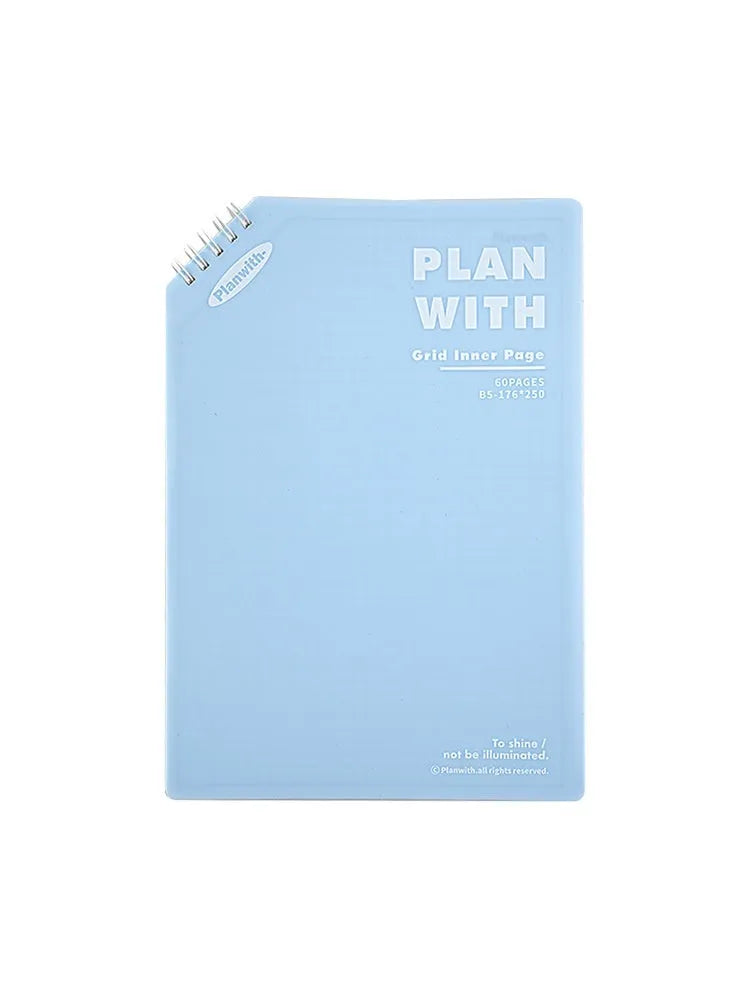 Oblique angle bound notebook in A5 or B5 size with a blue plaid or white cover, open to show pages.
