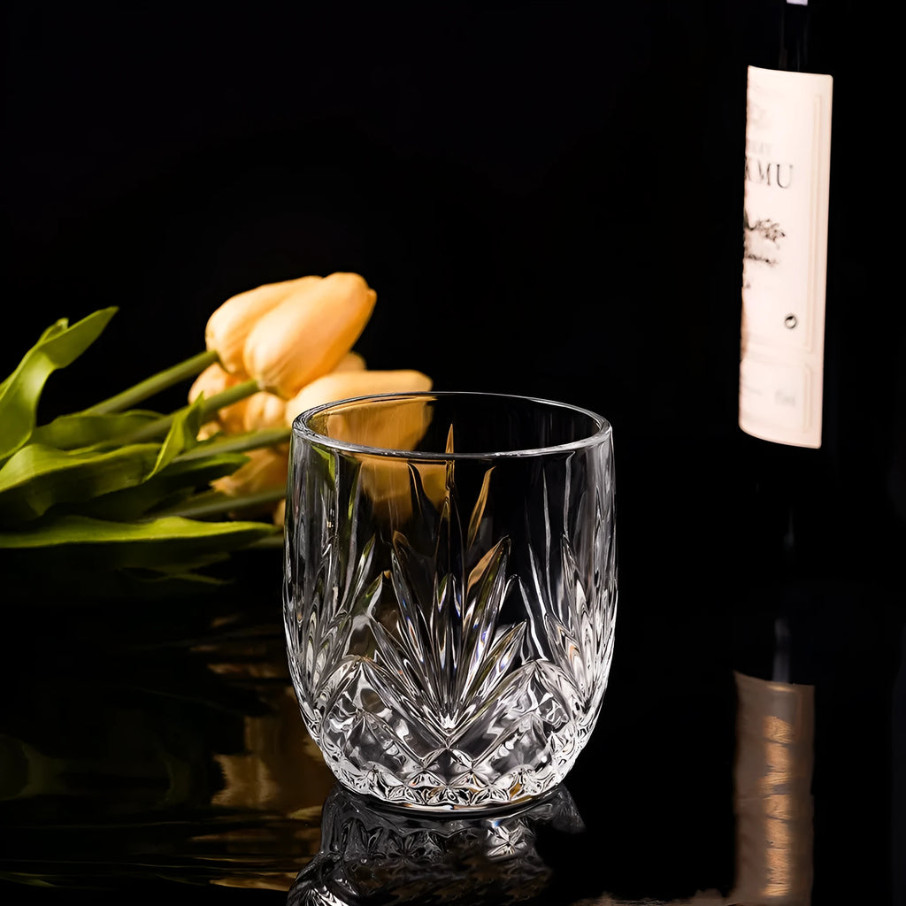 Thick bottom crystal whiskey shot glass in a selected colour style on a table.