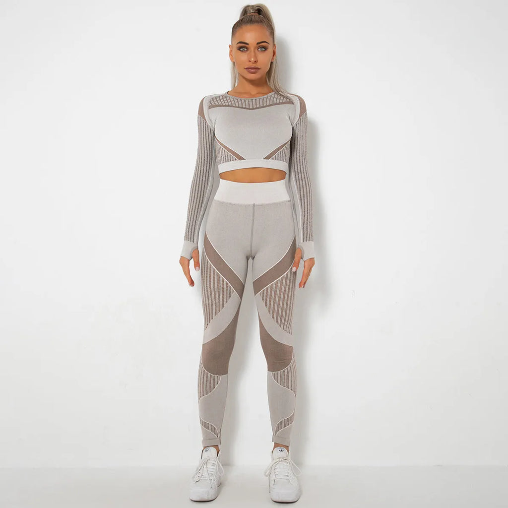 Woman wearing a seamless long-sleeved striped yoga suit in a stretch pose.