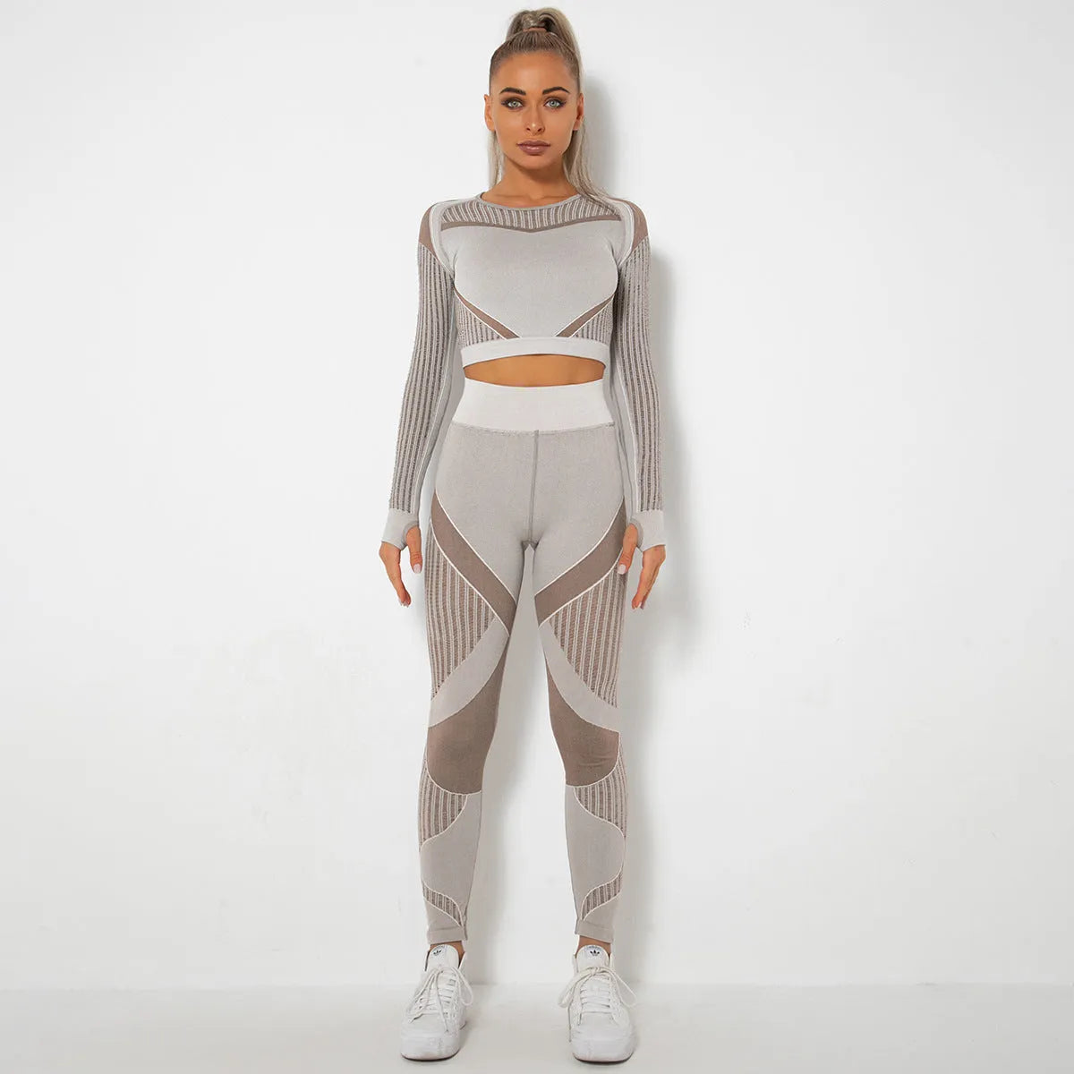 Woman wearing a seamless long-sleeved striped yoga suit in a stretch pose.