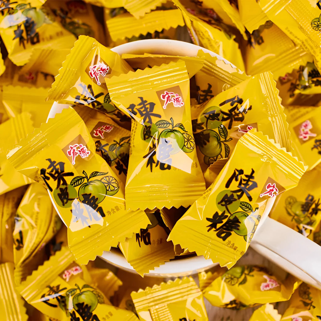 Assorted hard candies in plum, guava, and tangerine peel flavours in a bag.
