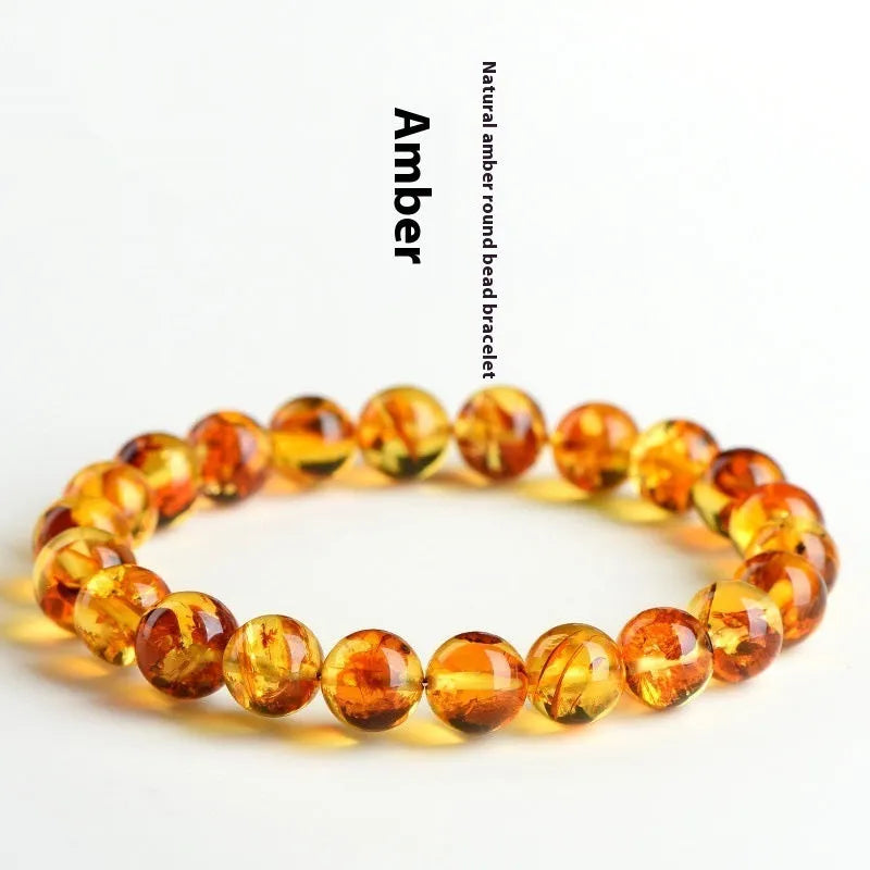 Natural yellow amber bracelet with piebald spots, showing geometric beads on a wrist.