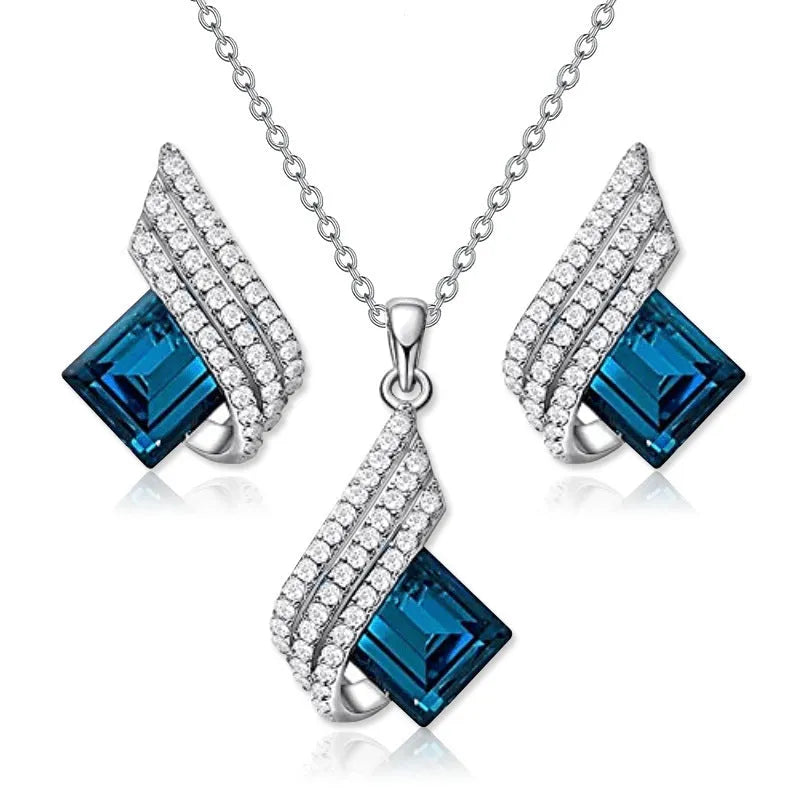 Alloy pendant necklace and matching earrings with glass ornamentation and cross chain design