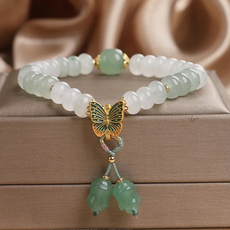 Green crystal women's bracelet with abacus beads and butterfly tassel decoration