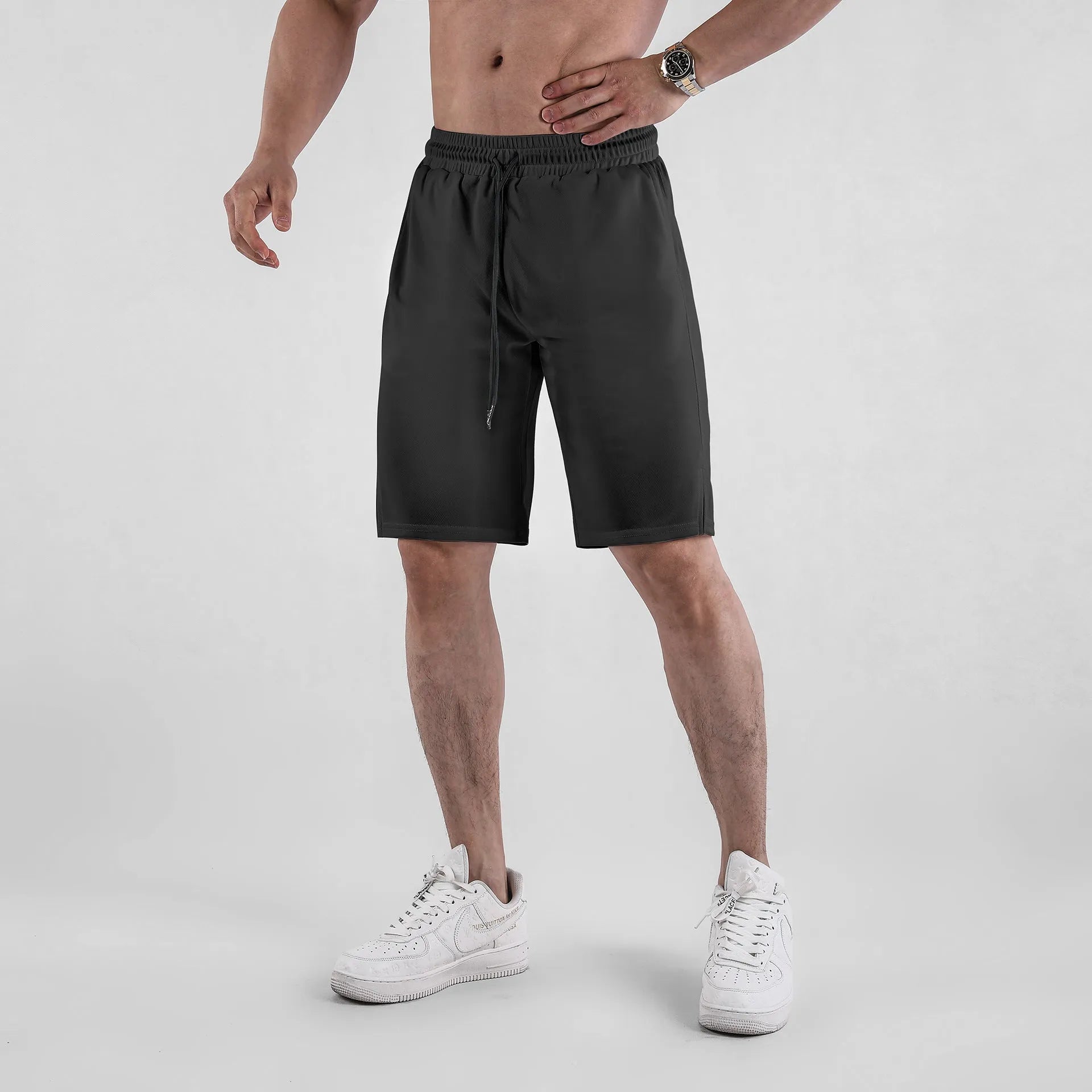 Men's black quick-drying mesh shorts with elastic waistband, shown in a loose casual fit.