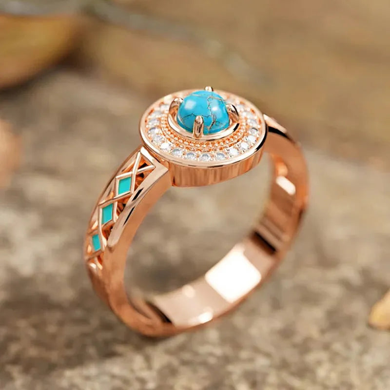 Women's geometric turquoise ring with zircon inlay on rose gold copper band, showing ethnic style design