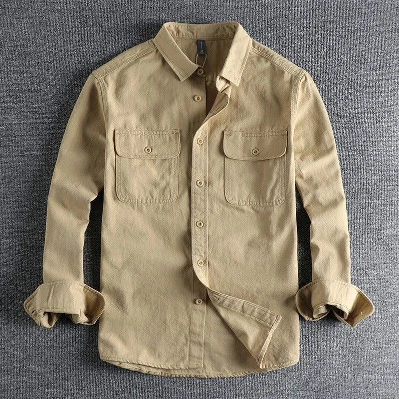 Man wearing a loose fit long sleeve cardigan shirt in light grey polyester.