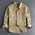 Man wearing a loose fit long sleeve cardigan shirt in light grey polyester.
