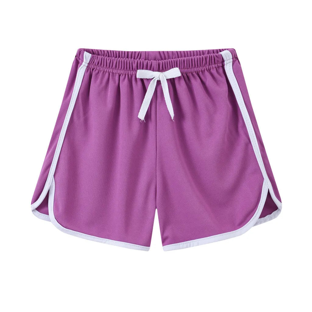 Children's colourful polyester shorts with elastic waistband, showing patterns like stripes, pineapples, and kittens.