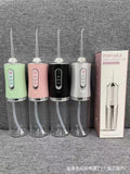 Pink electric water flosser with nozzle and water tank on a bathroom surface