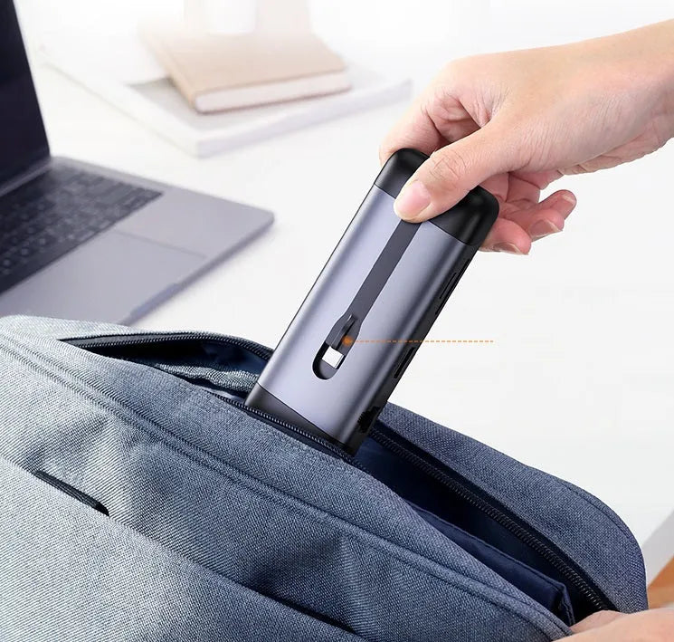 USB-C expansion dock adapter with short cable, showing HDMI, USB 3.0, and Power Delivery ports.