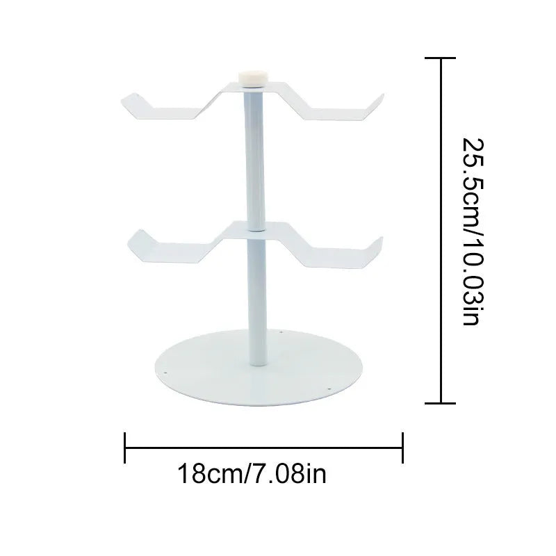 Black two-layer metal headphone bracket holding gaming headsets on a desk