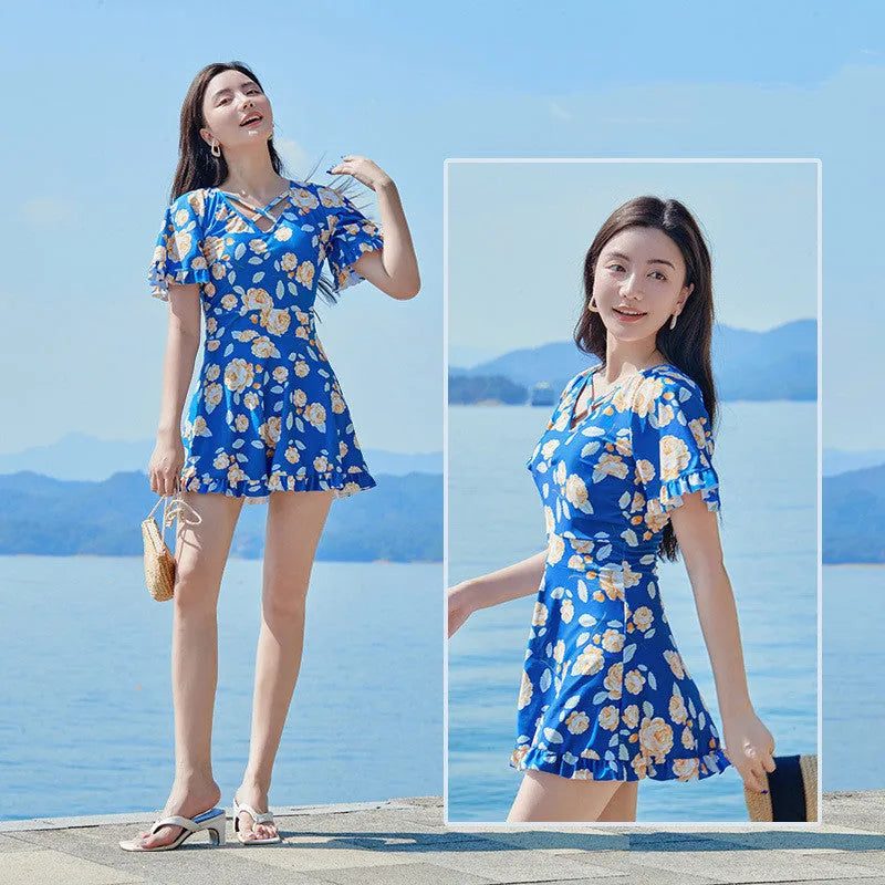 Women's high-waist one-piece swimsuit with floral print in blue and white.