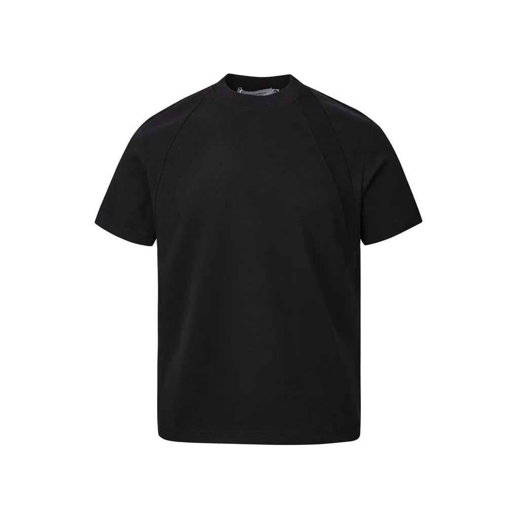 Man wearing a loose-fit black short sleeve top with visible air layer stitching detail.