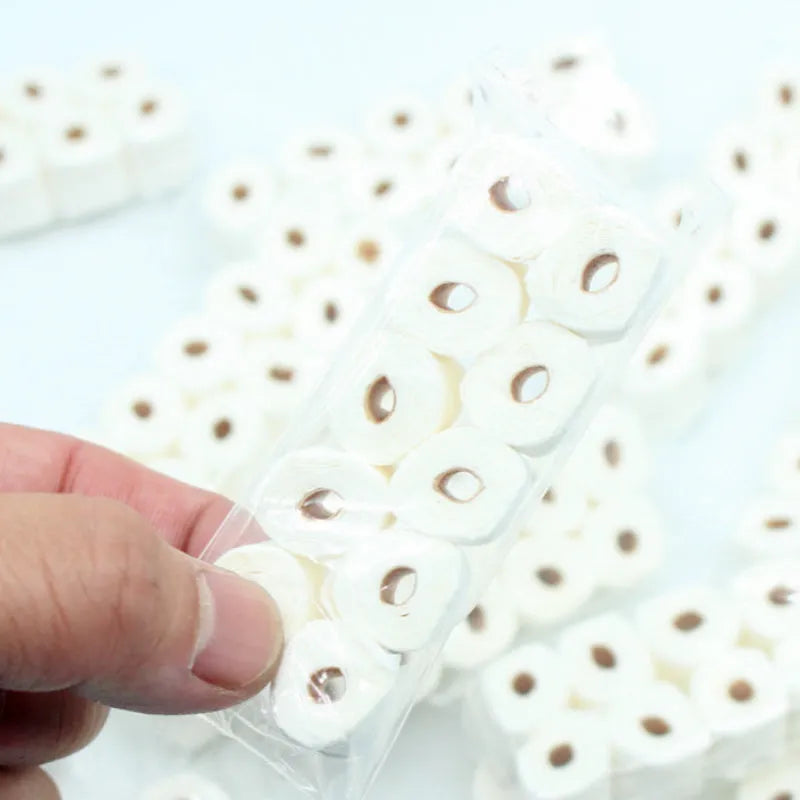 Small paper model of a tissue roll on a core, measuring 30mm by 15mm by 80mm.