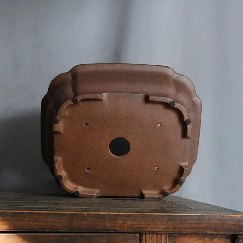 Purple sand rectangular ceramic bonsai pot on a flat surface.