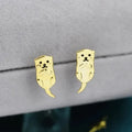 Simple compact three-dimensional animal-shaped copper earrings with electroplated finish in white gold colour