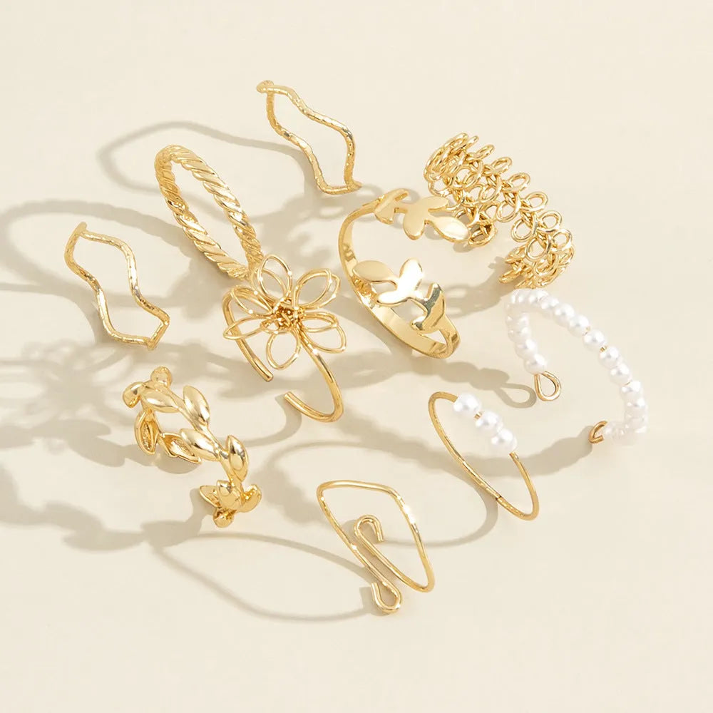Gold openwork flower ring with alloy construction and electroplated glossy finish