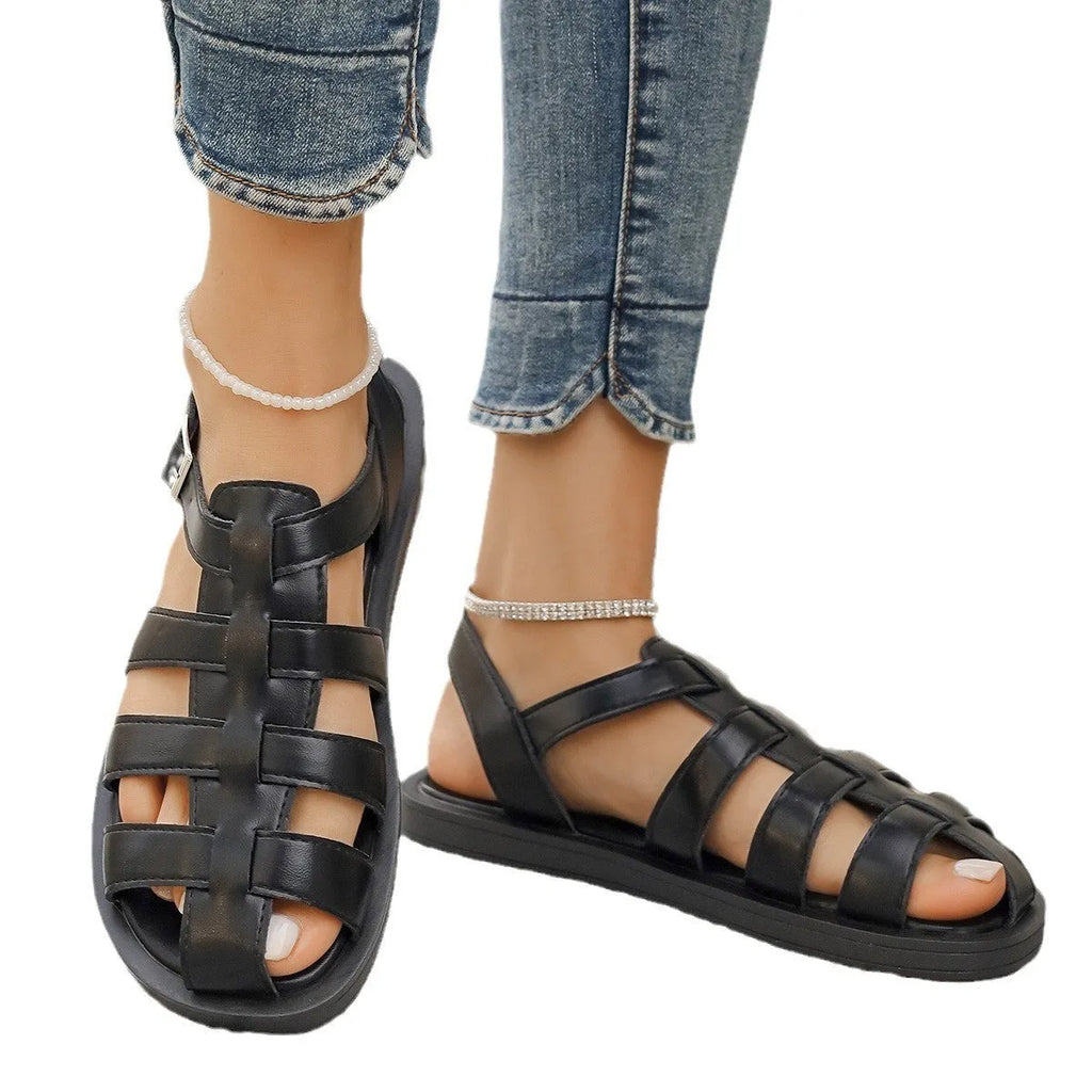 Flat Roman style women's sandals with PU upper and buckle fastening in black