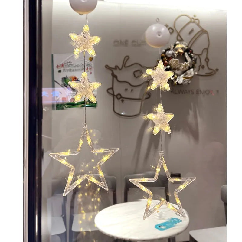 Set of three Christmas LED star window lights with suction cups on a glass window, warm glow, plastic housing, battery operated