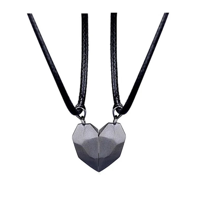 Gold-plated magnetic faceted heart pendant necklace in black and white on display