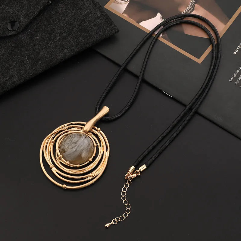 Gold geometric sweater chain necklace with adjustable snakeskin rope chain and large round pendant