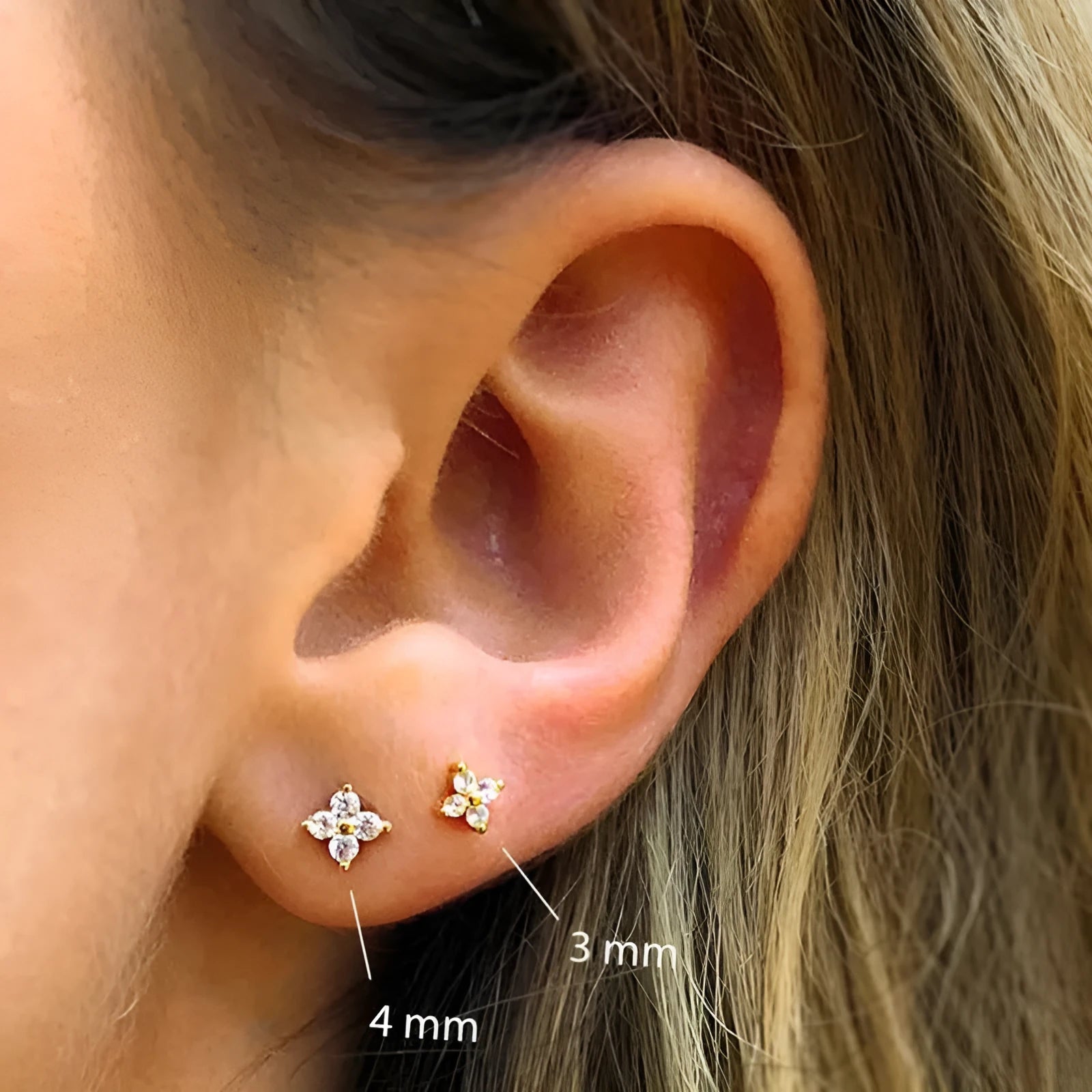S925 sterling silver stud earrings with small petal-shaped crystal flowers in gold or platinum finish.