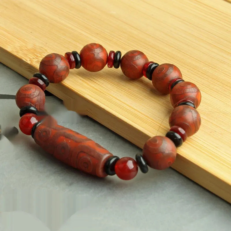 Distressed agate Tibet beads bracelet with three eye dzi design and polished stone beads