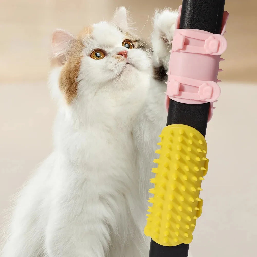 Silicone cat grooming massage comb with adjustable strap mounted on a table leg.
