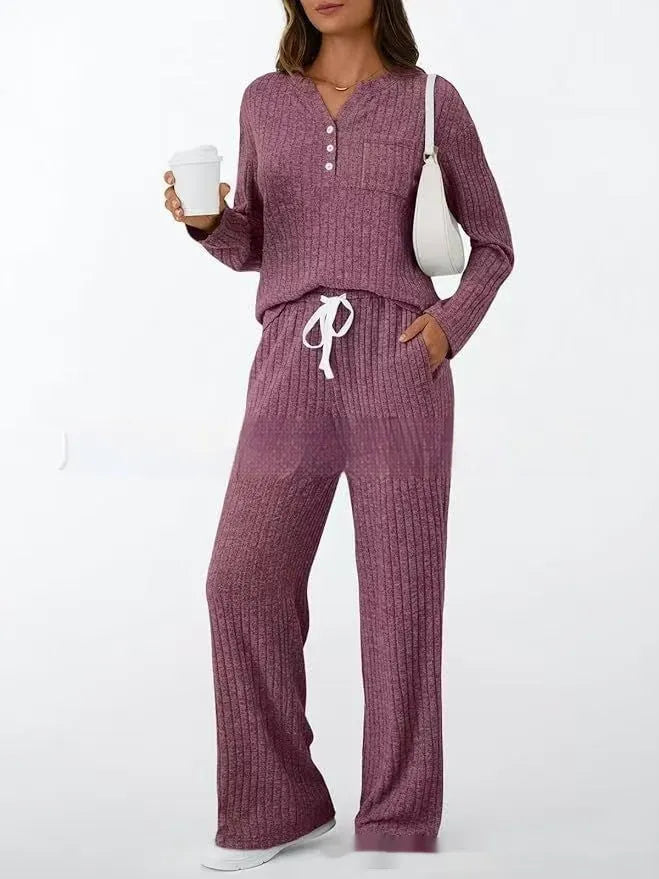 Knitted V-neck striped long coat with long sleeves, pockets, and a lace-up detail on a hanger.