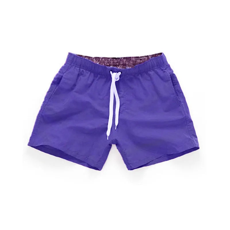 Men's straight-leg polyester beach shorts in multiple colours on a size chart showing S to 4XL.