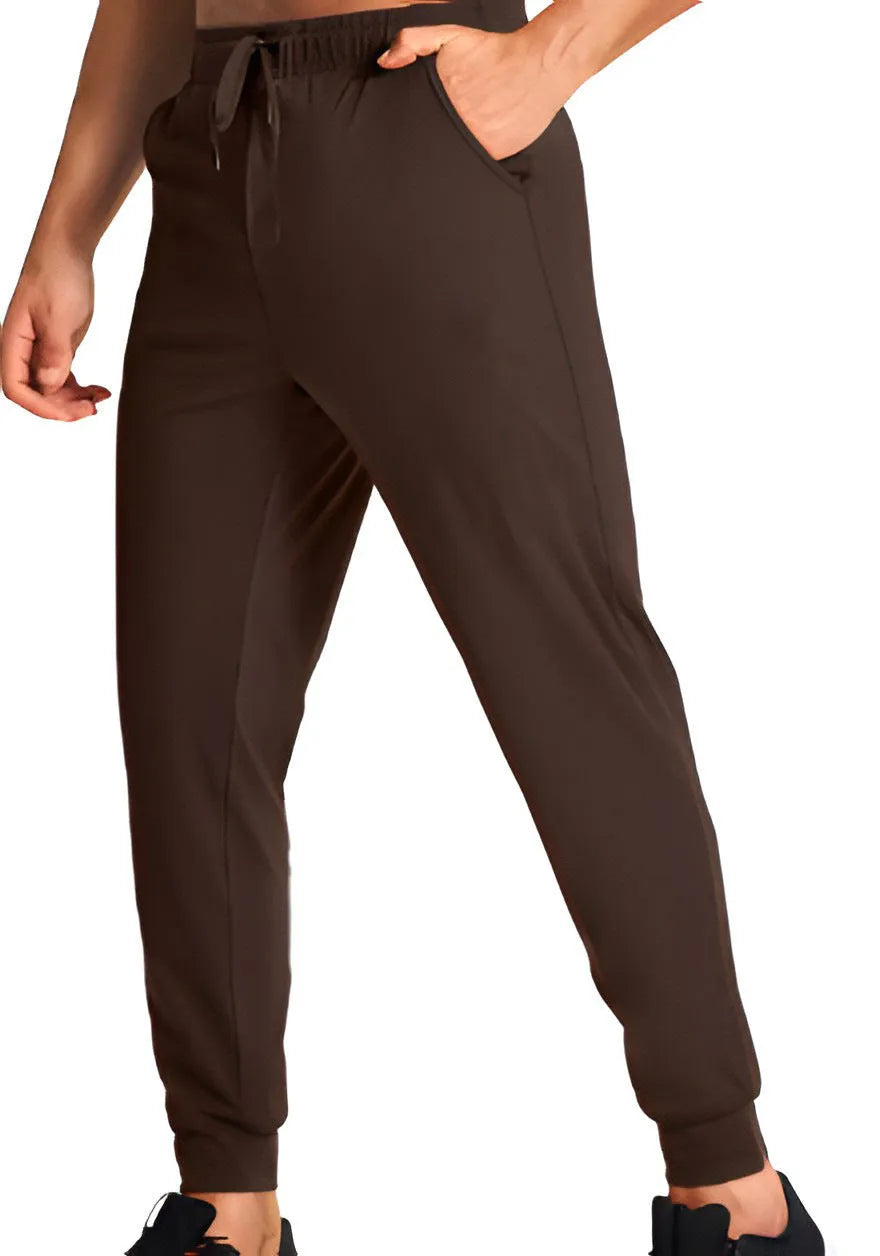 Men's solid colour loose fit casual trousers in polyester fabric on a hanger.