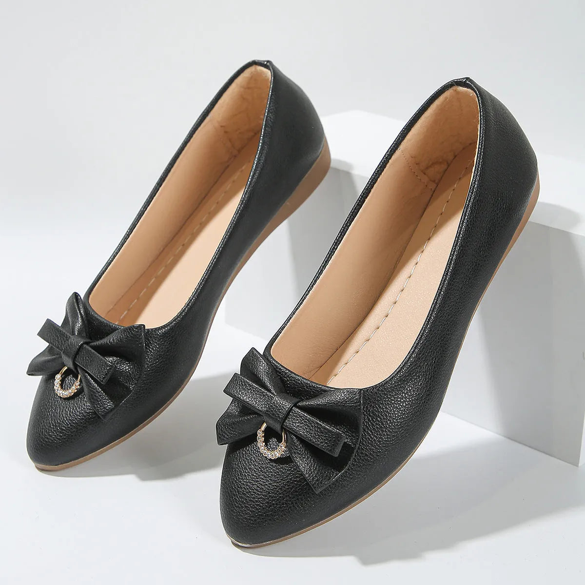 Women's beige flat casual shoes with a bowknot on the shallow mouth and a round toe.