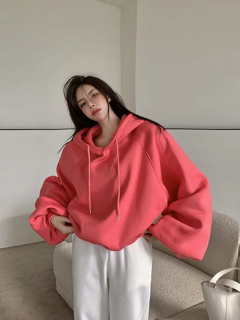 Women's loose watermelon red hooded sweater made from mulberry silk, shown sleeveless.