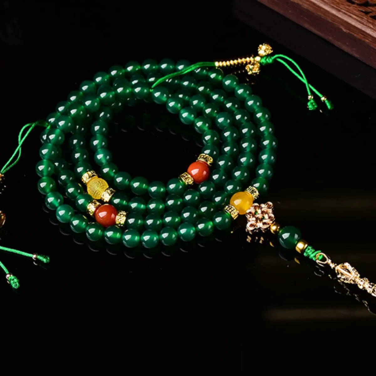 Handmade multi-strand green agate bracelet from Brazil on a wrist, showing stone sizes 6mm, 8mm, and 10mm.